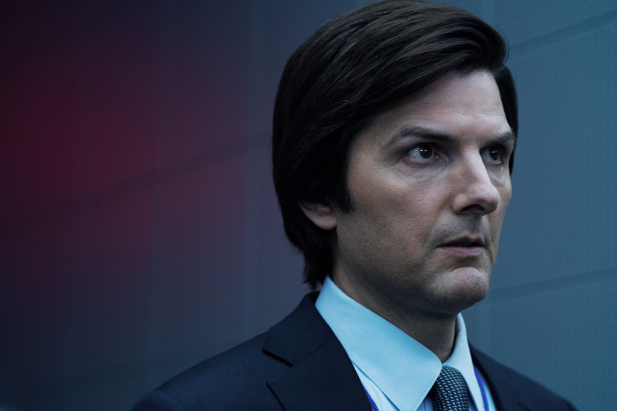 Adam Scott in 'Severance' Season 2, wearing a suit, staring ominously offscreen