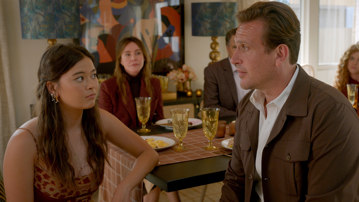 Lukita Maxwell and Jason Segel in 'Shrinking,' shown looking awkwardly at each other at the Thanksgiving dinner table